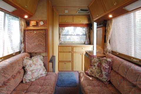 Inside view of a small caravan with red furniture