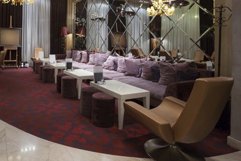 Fancy seating area of a hotel with purple sofas