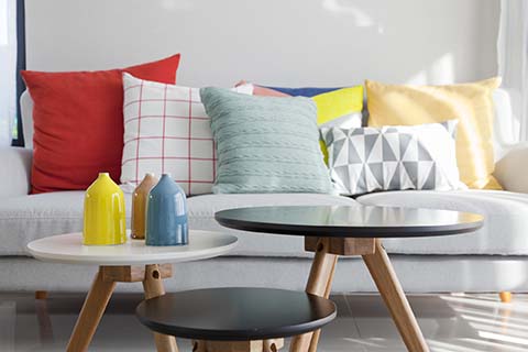 Grey sofa with a range of multi coloured cushions