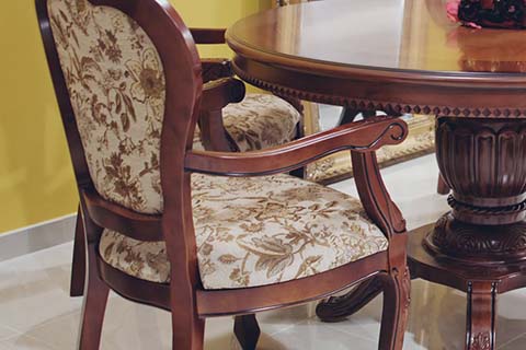 Old style wooden chair with floral cushion