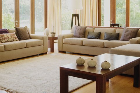 Corner cream sofa in home with oak floor and cream rug